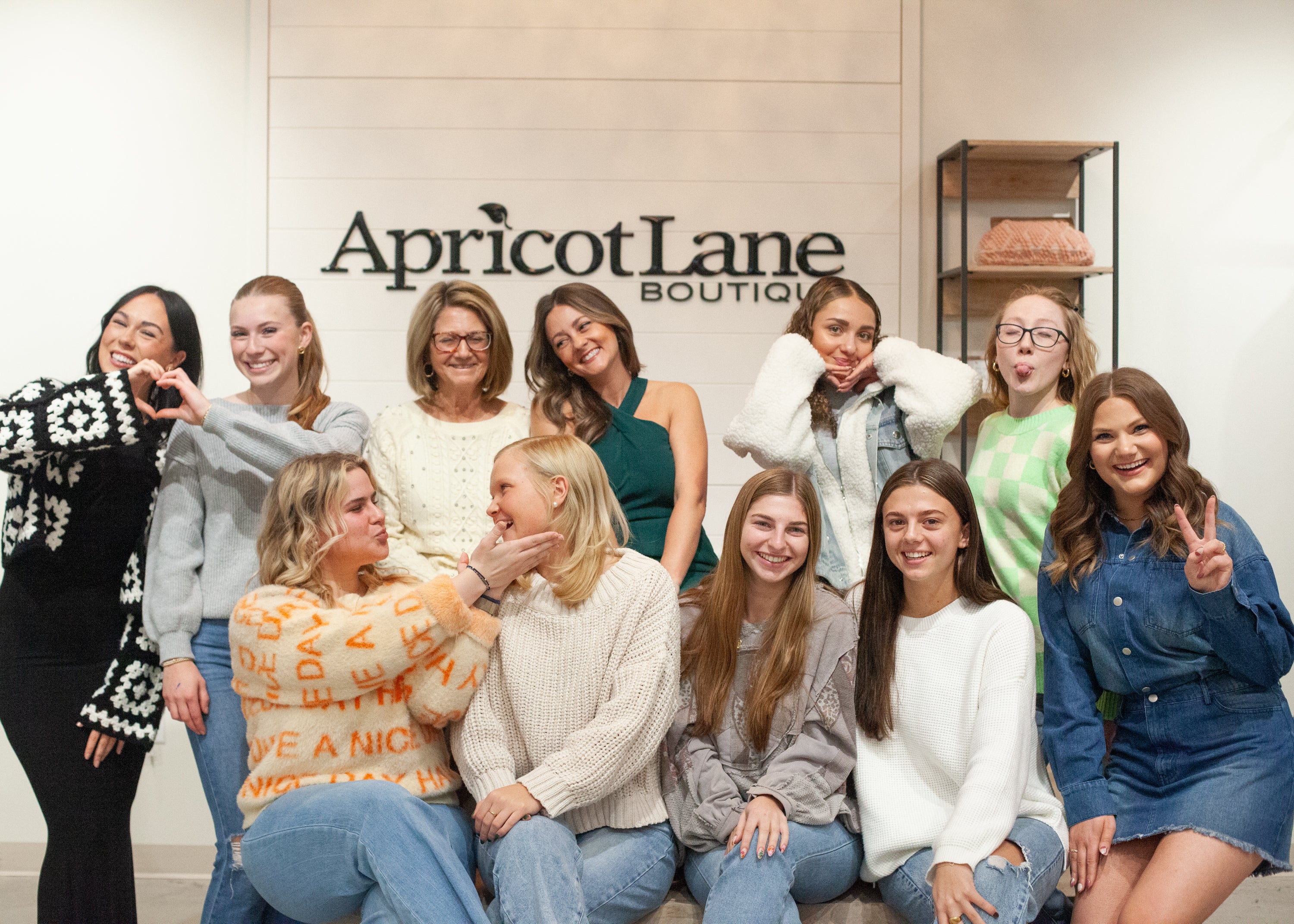 group of girls in trendy clothing posing in a silly way